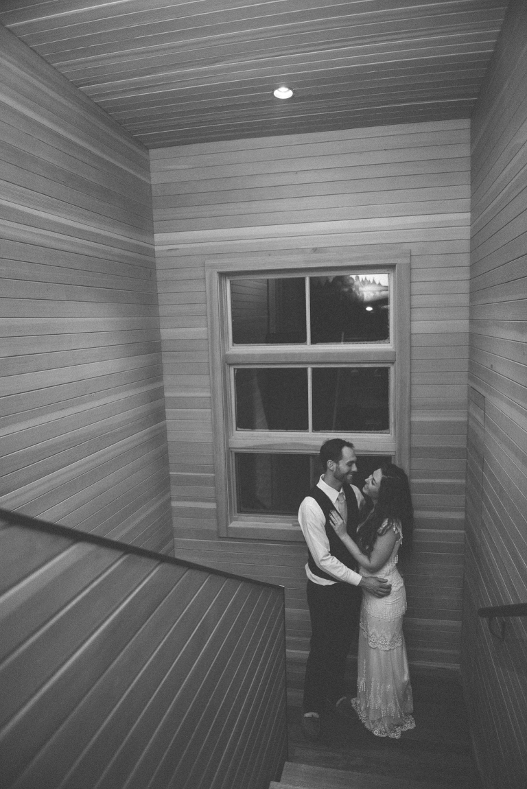 bride and groom standing in stairwell